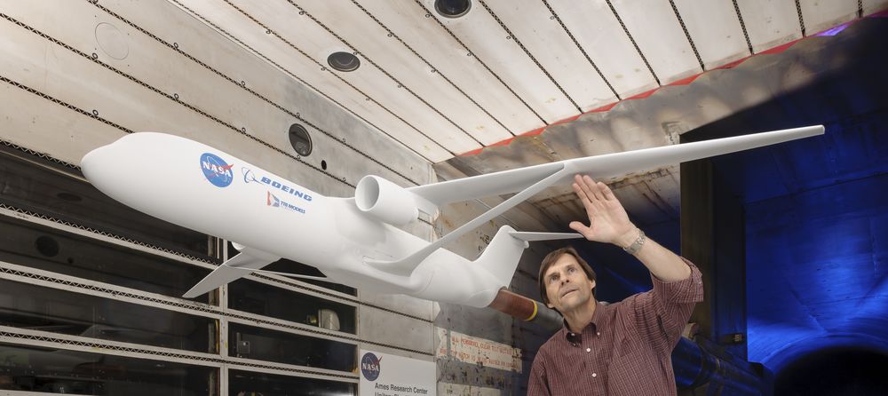 NASA aerospace research engineer Greg Gatlin inspects a truss-braced wing model at NASA Ames Research Center.